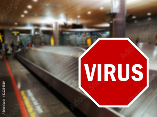 Wuhan coronavirus pandemic concept with STOP sign with the word virus superimposed on empty airport terminal