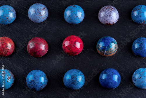  Multi-colored chocolate candies in the glaze. Top view.