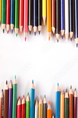 Colored pencils lie in a row
