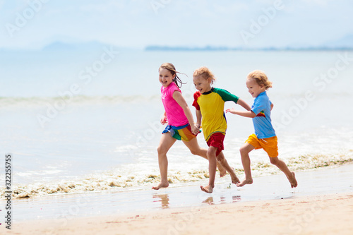 Kids playing on beach. Children play at sea.