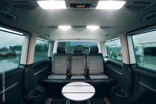 Interior of luxury van with comfortable leather seats and table