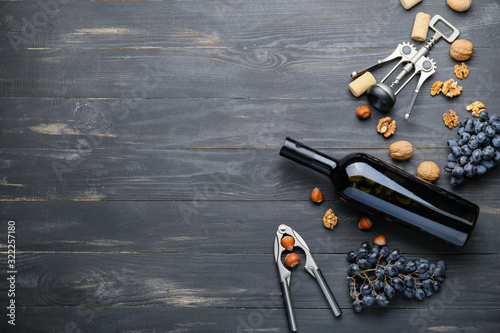 Delicious wine with nuts on dark wooden background