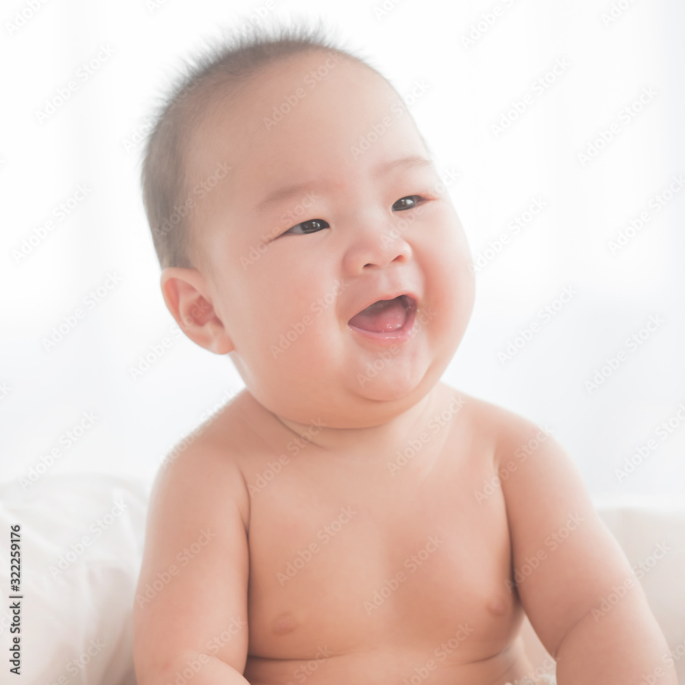 newborn child relaxing in bed. adorable baby boy in white sunny bedroom. nursery for young children. textile and bedding for kids. family morning at home. six month. childhood and baby care concept. newborn child relaxing in bed. adorable baby boy in white sunny bedroom. nursery for young children. textile and bedding for kids. family morning at home. six month. childhood and baby care concept.