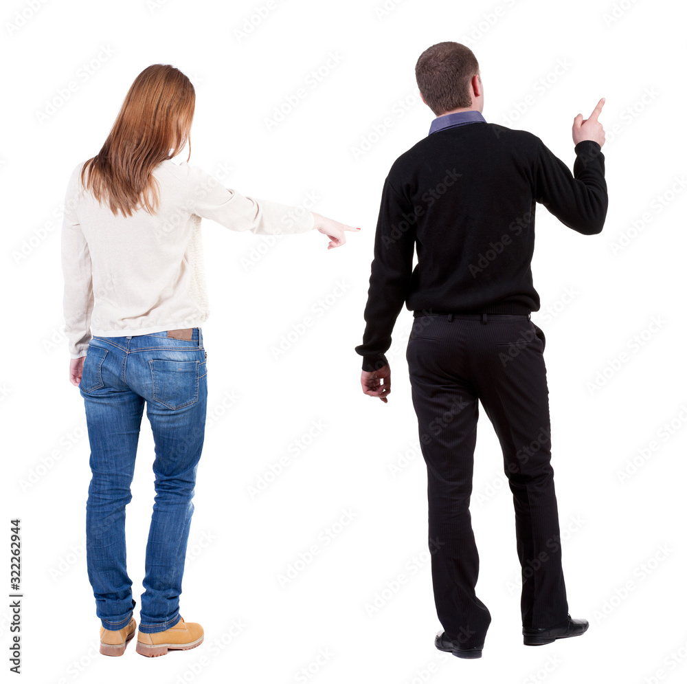 Back view of couple couple in sweater pointing. Back view of couple couple in sweater pointing.