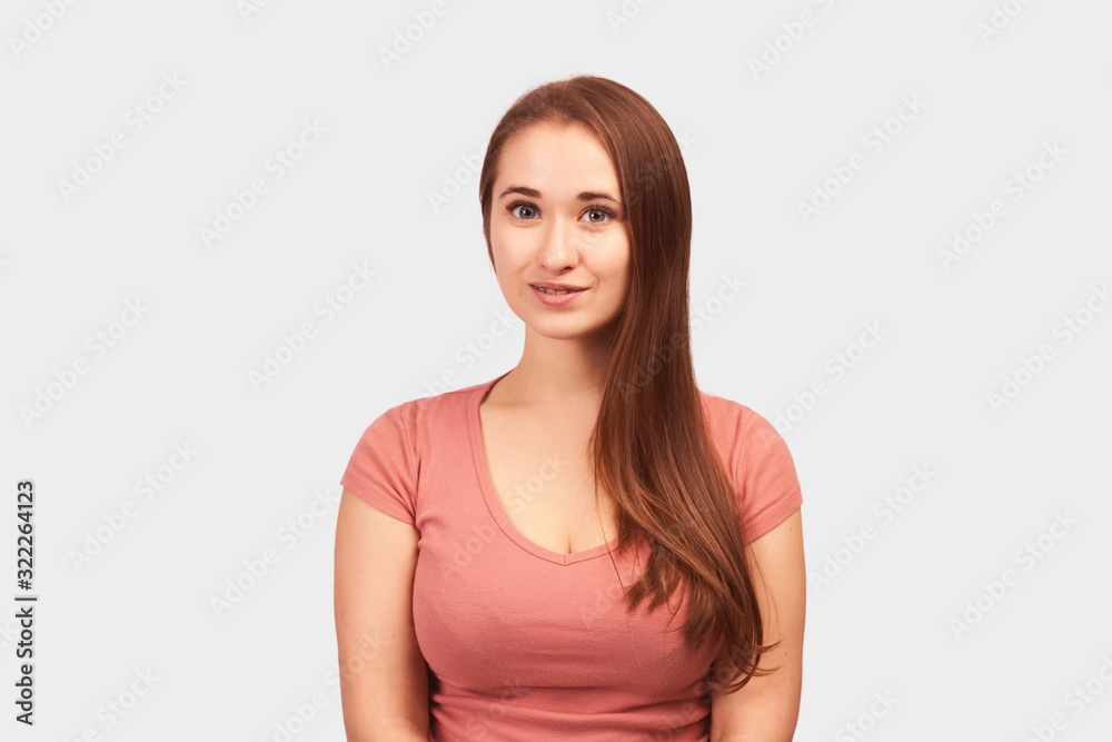 Young beautiful girl isolated on white background in Studio. Woman looks with calm expression, People, natural beauty and concept of youth Young beautiful girl isolated on white background in Studio. Woman looks with calm expression, People, natural beauty and concept of youth