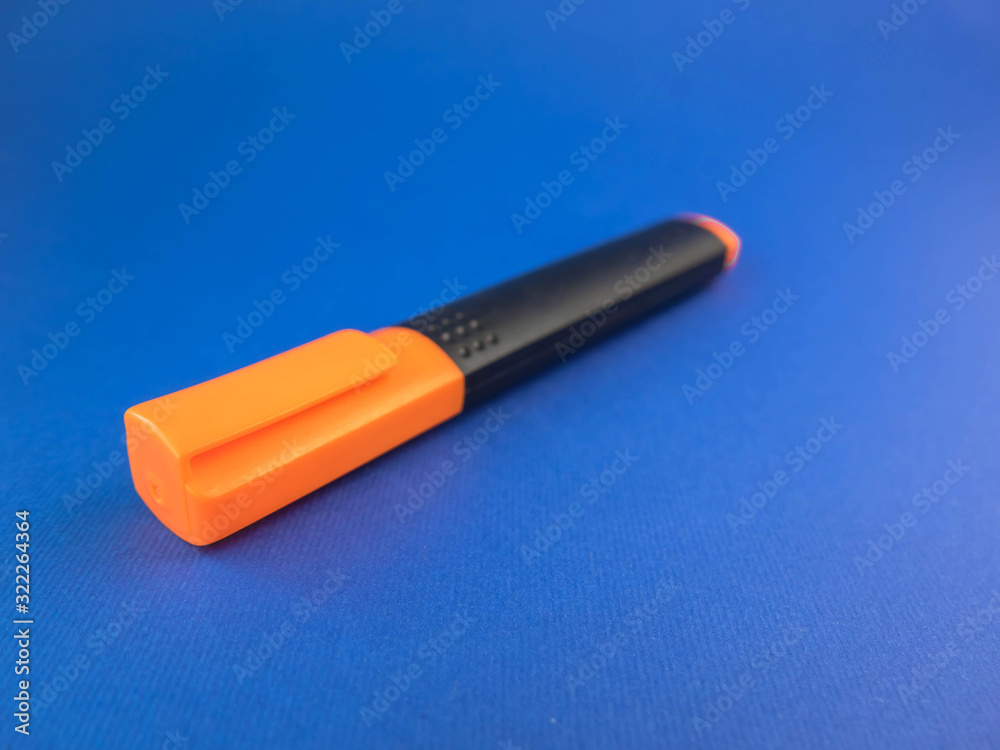 orange marker on a blue background orange marker on a blue background