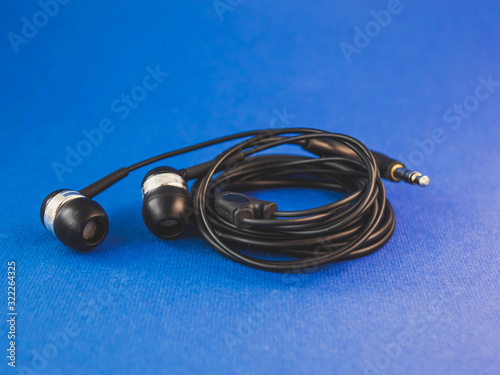 black headphones on a blue background wrapped in a circle