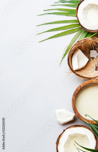 Coconut non dairy vegan milk in wooden bowl. Gray backgound top view with copy space, hard light