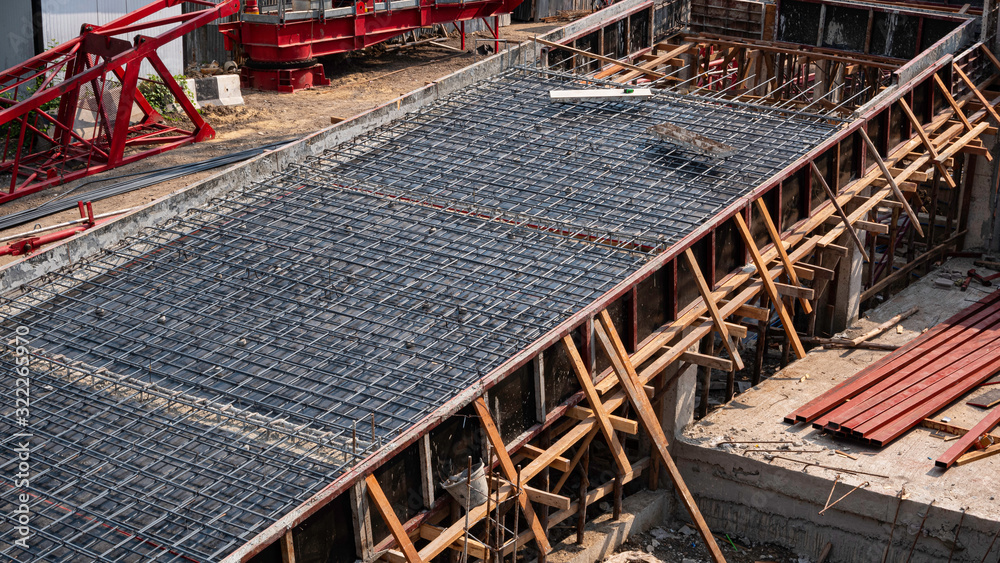 High angle and diagonal view of reinforcement metal framework for concrete pouring on ramp way structure in construction site