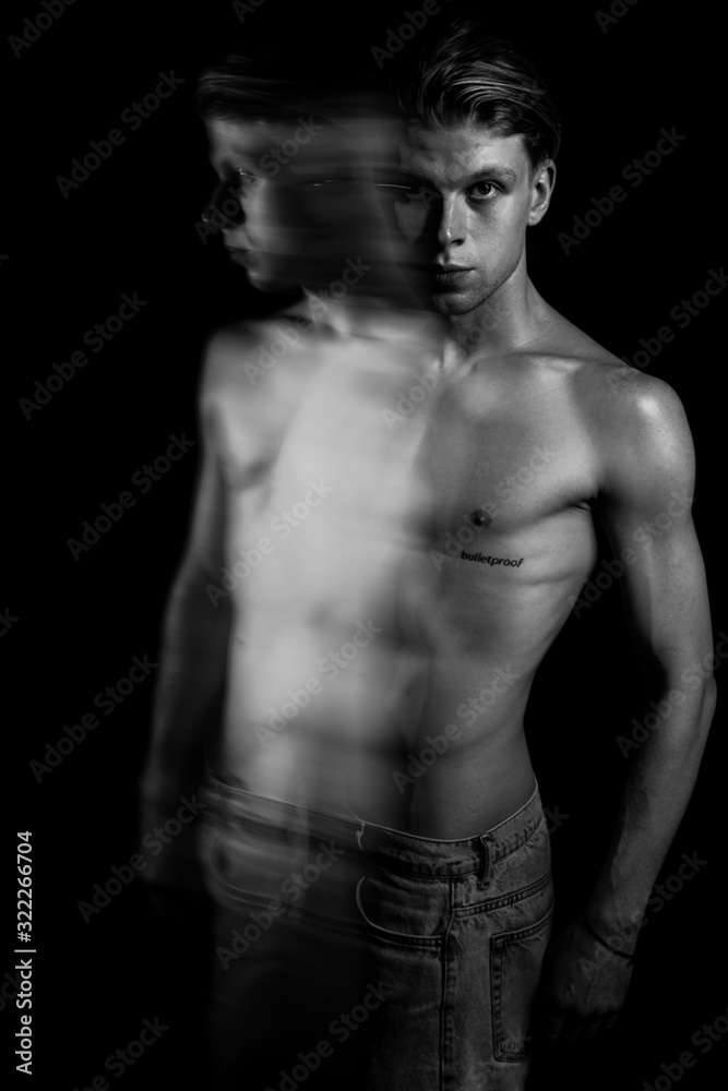 sports sexy naked torso handsome man portrait. Long exposure. Creative artistic technique of expressive emotional portraits. Black and white. tension 