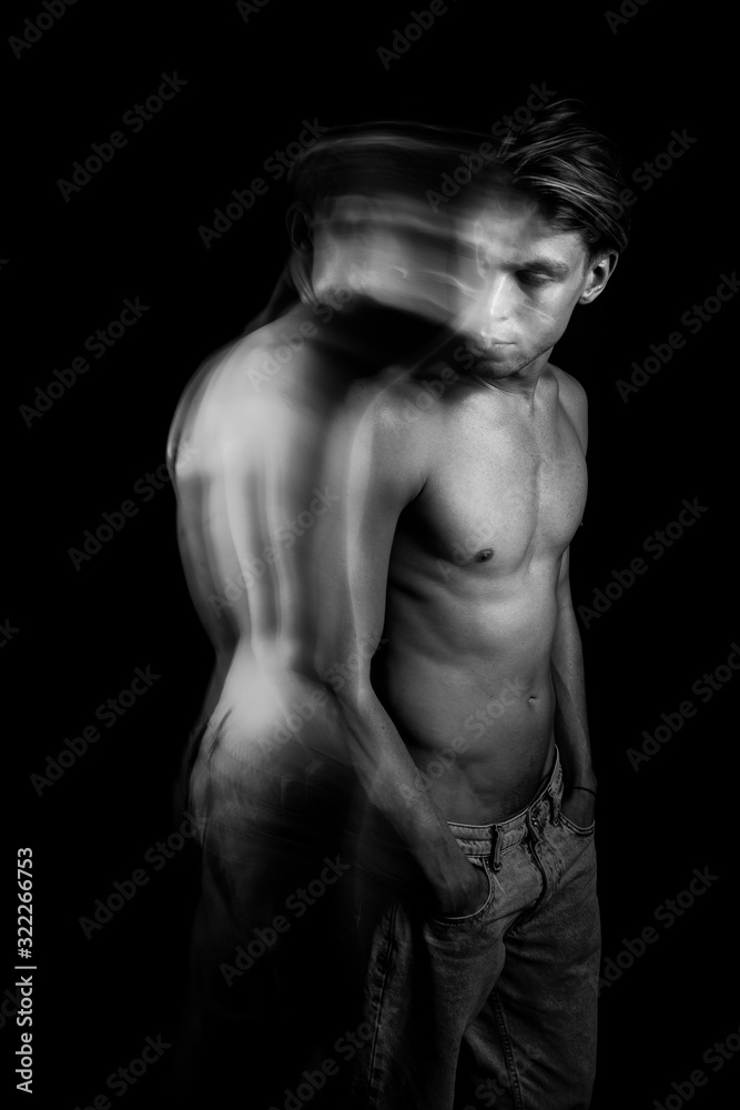 young sexy guy looking back. Symbolic metaphorical images. the ghost is haunting. doubts and thoughts. solve problems. depressed mood black and white artistic portrait