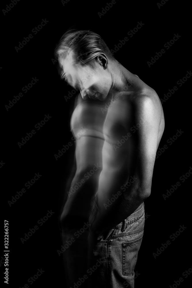 Naklejka premium lyrical romantic guy bowed his head. depressed pensive mood. ghosts from the past. monochrome black and white stylish naked torso young sexy man portrait. Creative design