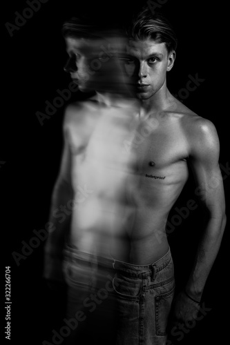 sports sexy naked torso handsome man portrait. Long exposure. Creative artistic technique of expressive emotional portraits. Black and white. tension 