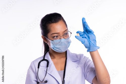 Doctors wear masks while looking at medicine