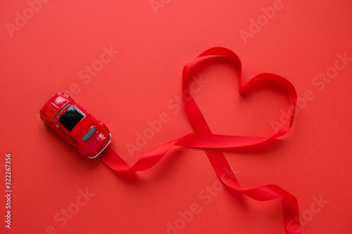 Wallpaper Mural Red car toy carries Valentine's ribbon. Red ribbon in the shape of heart. Torontodigital.ca
