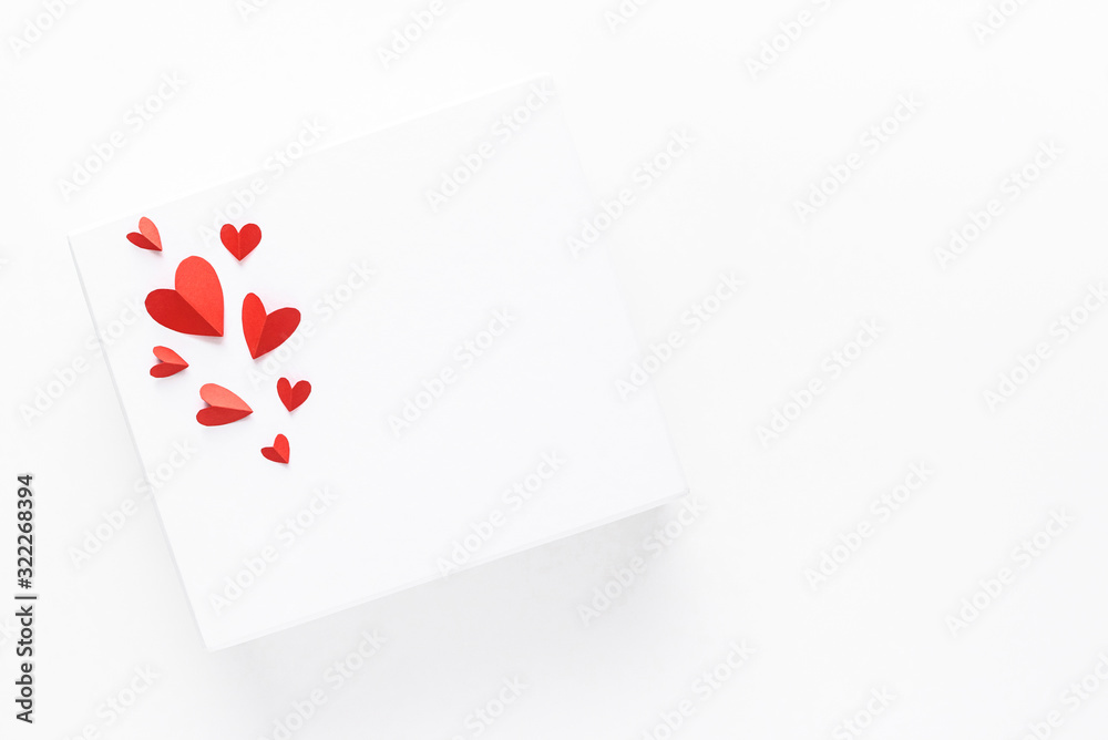 Valentine's day. Beautiful red paper hearts on a white surface. Top view.