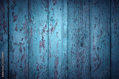 Crackled paint on old dark blue wood planks.