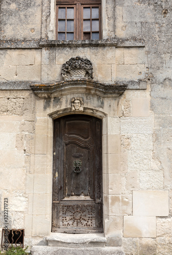 Old wooden door on stone  house  in Les Baux de Provence, France © wjarek