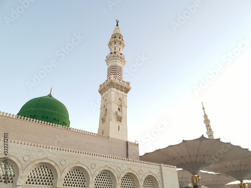 Medina, Saudi Arabia - August 25, 2019: Sunrise or golden hour view during haze weather at Nabawi Mosque or Prophet Mosque in Medina, Saudi Arabia.