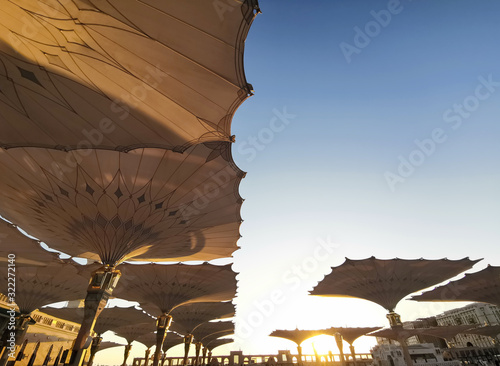 Medina, Saudi Arabia - August 25, 2019: Sunrise or golden hour view during haze weather at Nabawi Mosque or Prophet Mosque in Medina, Saudi Arabia.