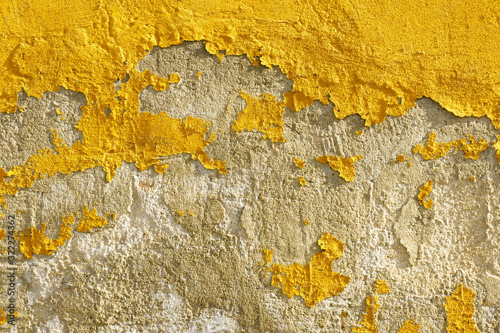 Naklejka premium Old weathered painted yellow color peeling wall grunge background