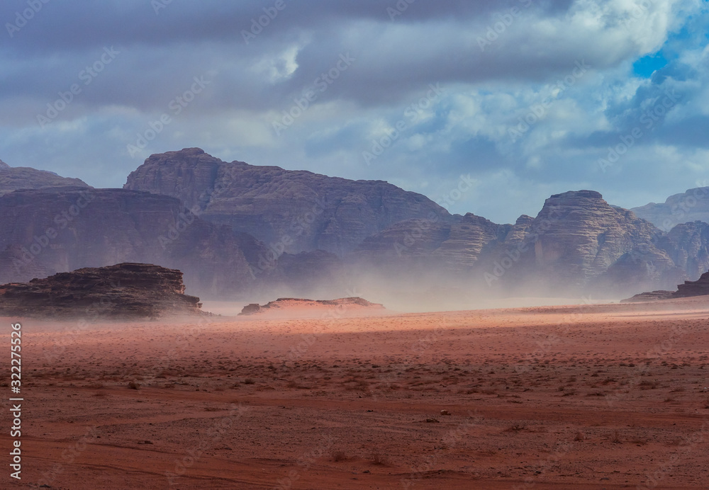 Beautiful Scenery Scenic Panoramic View Red Sand Desert and Ancient Sandstone Mountains Landscape in Wadi Rum, Jordan during a Sandstorm