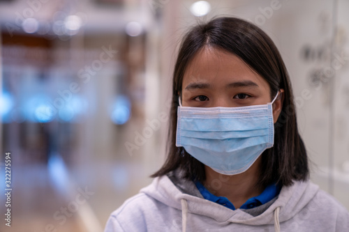 A women wearing a dust mask PM2.5,Corona virus,Corona 2020,Portrait Asian children girl wear N95 mask to protect PM 2.5 dust and air pollution.