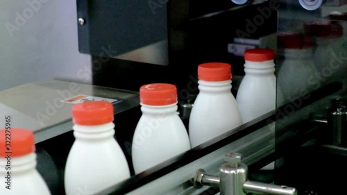 Close-up plastic bottles being transported into the production line in industrial machinery on smart factory, industry 4.0 technology