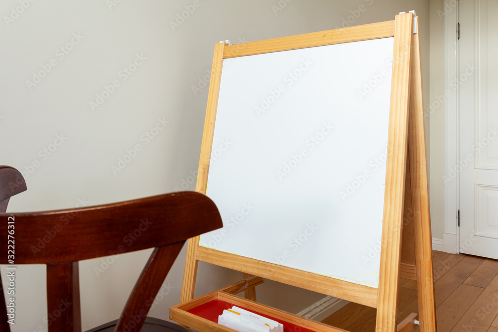 children's easel for painting in a bright room children's easel for painting in a bright room
