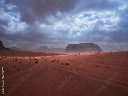 Beautiful Scenery Scenic Panoramic View Red Sand Desert and Ancient Sandstone Mountains Landscape in Wadi Rum, Jordan during a Sandstorm