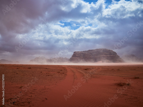 Beautiful Scenery Scenic Panoramic View Red Sand Desert and Ancient Sandstone Mountains Landscape in Wadi Rum  Jordan during a Sandstorm