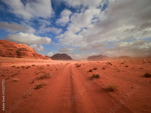 Beautiful Scenery Scenic Panoramic View Red Sand Desert and Ancient Sandstone Mountains Landscape in Wadi Rum  Jordan during a Sandstorm