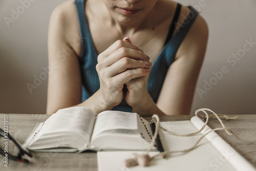 Woman hand with Bible praying in christian concept.