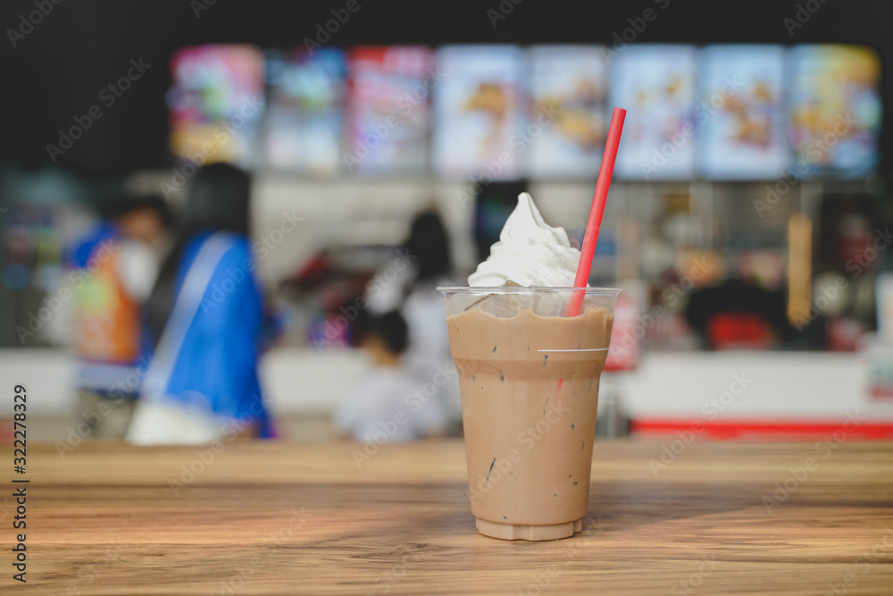 cold drink in transparent glass with whipped cream on blurred restaurant background cold drink in transparent glass with whipped cream on blurred restaurant background