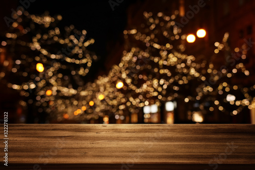 background Image of wooden table in front of street abstract blurred lights view