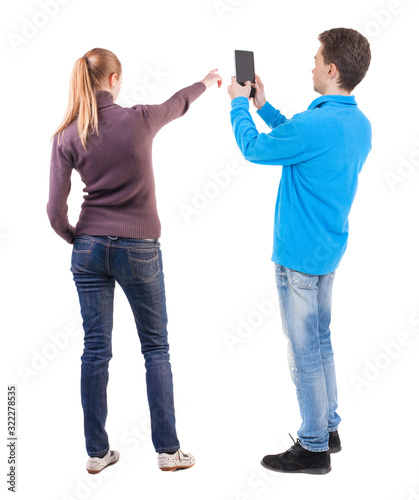 Back view of couple in sweater with mobile phone.