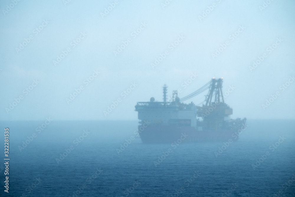 Offshore ship crane in the sea fog