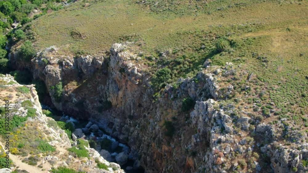 Aerial view flying over gorge viewing river below, viewing canyon, rugged landscape, drone shot. Aerial view flying over gorge viewing river below, viewing canyon, rugged landscape, drone shot.