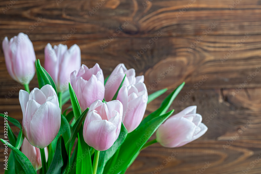 Bouquet of pink tulips for the holidays. Women's Day, Valentine's Day, name day. On a wooden background.