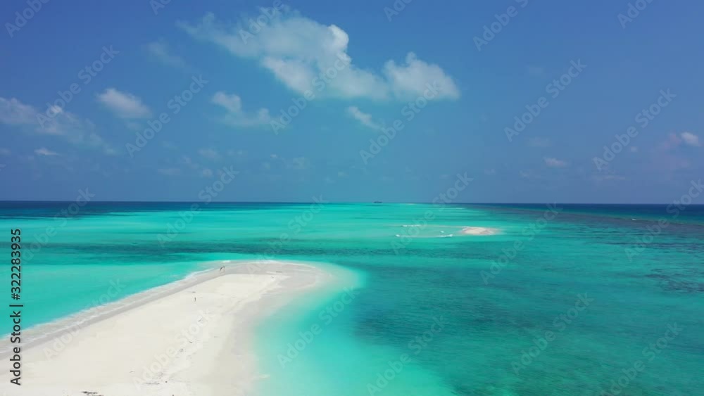 White sand sandbar in the middle of the endless turquoise sea. Sunny day with white fluffy clouds, Maldives White sand sandbar in the middle of the endless turquoise sea. Sunny day with white fluffy clouds, Maldives