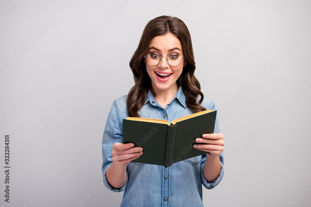Photo of pretty funny business lady hold book hands addicted reader book worm amazing exciting happy ending wear specs casual jeans denim shirt isolated grey color background Photo of pretty funny business lady hold book hands addicted reader book worm amazing exciting happy ending wear specs casual jeans denim shirt isolated grey color background