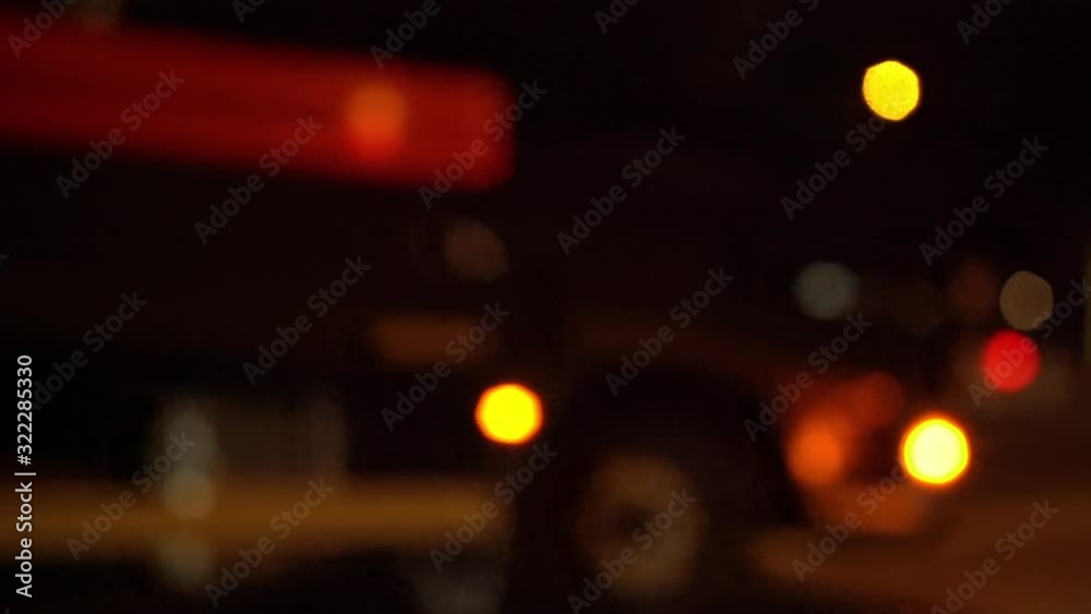 Defocused view of city traffic passing by on a busy intersection Defocused view of city traffic passing by on a busy intersection