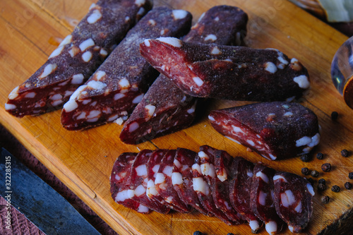 dried pork sausages composition on a wooden background