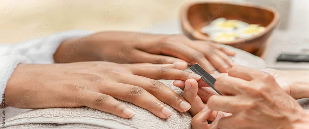 Fototapeta premium Master in the cabin makes the manicure girl