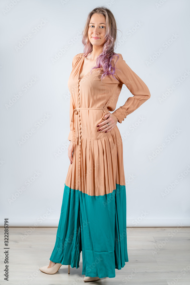 Girl in a coffee-colored dress with blue isolated on a white background. Girl in a coffee-colored dress with blue isolated on a white background.