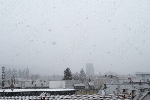 Snow is falling in front of the neckar tower in villingen-schwenningen, wintertime view over schwenningen city  photo