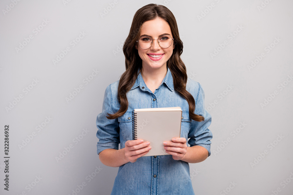 Photo of beautiful freelancer lady hold paper planner diligent reliable student toothy smiling wear specs casual jeans denim shirt isolated grey color background Photo of beautiful freelancer lady hold paper planner diligent reliable student toothy smiling wear specs casual jeans denim shirt isolated grey color background