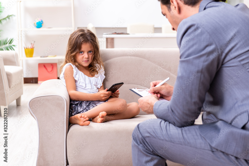 Child psychologist attending small girl Child psychologist attending small girl