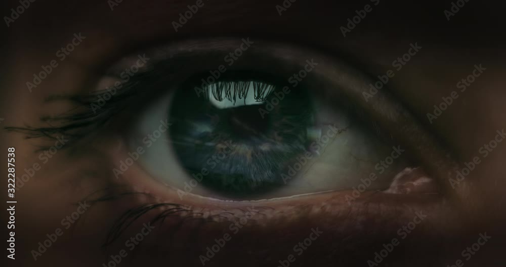 Female Racer in helmet. Macro shot of the eye with road reflections.