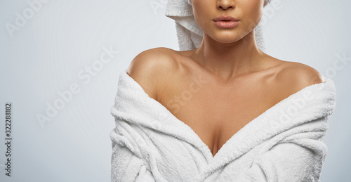 Woman in bathrobe and towel posing.